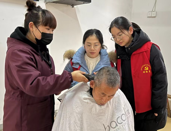 合肥市廬江縣泥河鎮居民劉正芳向青年志愿者傳授理發技術，弘揚志愿者精神